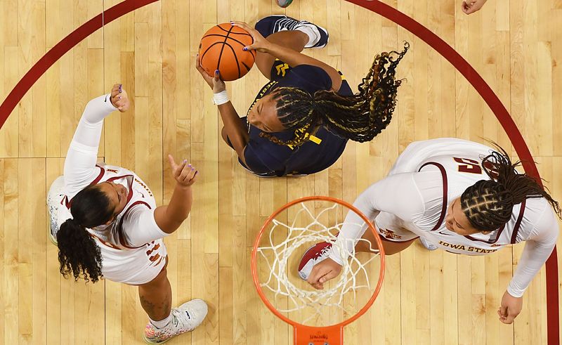 West Virginia Mountaineers forward Carter McCray (1) looks for a shot as Iowa State Cyclones' guard/forward Sydney Harris (25) and center Audi Crooks (55) defend during the fourth quarter in the Big-12 women’s basketball on Jan. 11, 2026, at Hilton Coliseum in Ames, Iowa.
