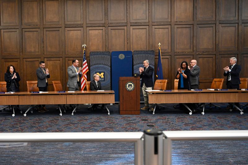 University of Michigan president-elect Kent Syverud, seated left center, reacts as the Board of Regents members congratulate him on being named the 16th president of the University of Michigan. Photo taken on Monday, Jan. 12, 2026, in Ann Arbor, Mich.