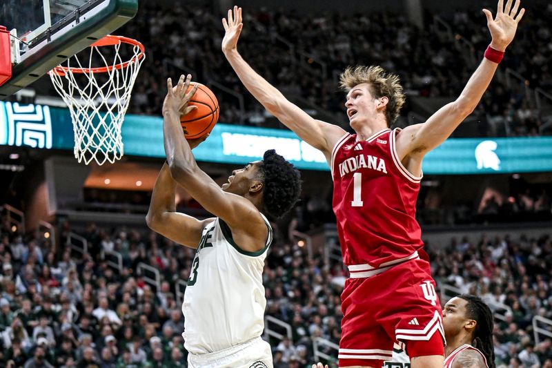 Michigan State's Cam Ward, left, scores and is fouled by Indiana's Reed Bailey during the second half on Tuesday, Jan. 13, 2026, at the Breslin Center in East Lansing.