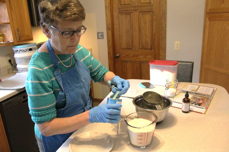 Nina Ochs of Monroe carefully measures ingredients to make anise cookies.