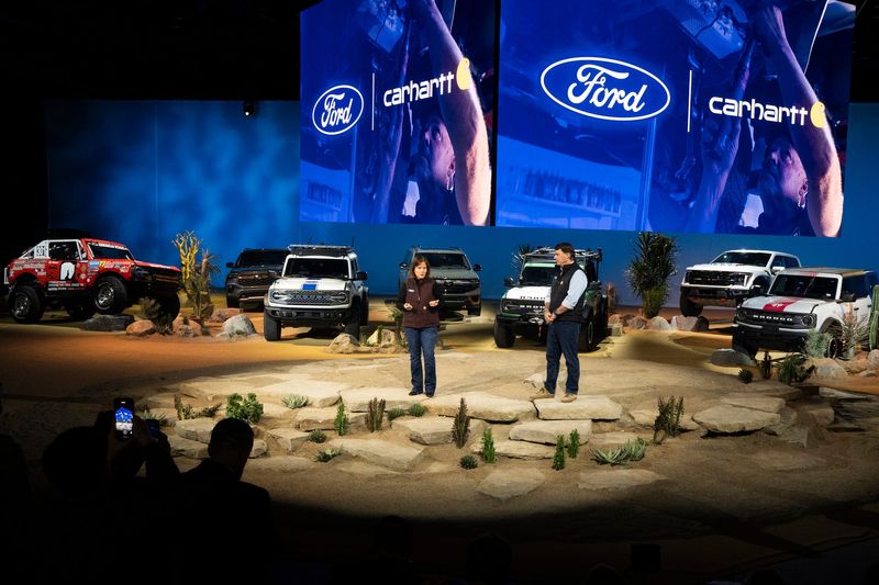 Carhartt CEO Linda Hubbard, left, and Ford CEO Jim Farley talk at Huntington Place in downtown Detroit on Tuesday, Jan. 13, 2026.