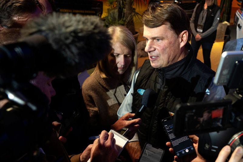 Ford CEO Jim Farley talks with reporters at Huntington Place in downtown Detroit on Tuesday, Jan. 13, 2026.
