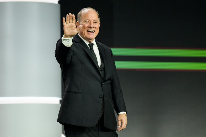 Former Detroit Mayor Mike Duggan waves to the crowd before participating in a ribbon cutting during the Detroit Auto Show Charity Preview on Friday, Jan. 16, 2026 at Huntington Place in Detroit.