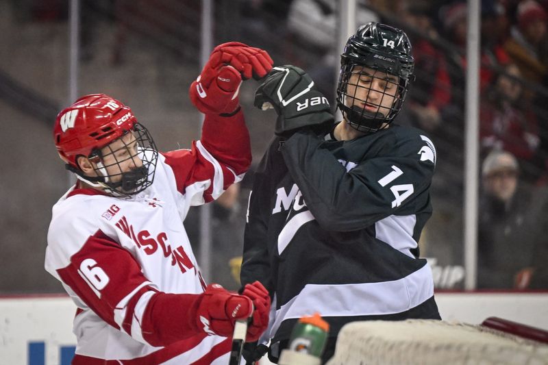 Michigan State defenseman Matt Lahey (14) shoves Wisconsin center Tyson Dyck (16) after the whistle in a game Friday, January 16, 2026, at the Kohl Center in Madison, Wisconsin.