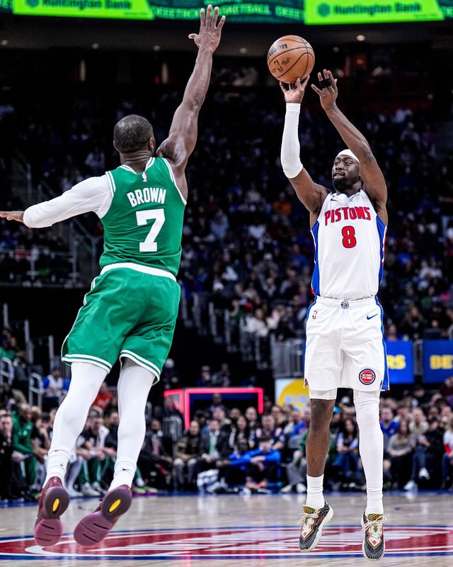 Detroit Pistons guard Caris LeVert (8) makes a jump shot against Boston Celtics guard Jaylen Brown (7) during the first half at Little Caesars Arena in Detroit on Monday, Jan. 19, 2026.