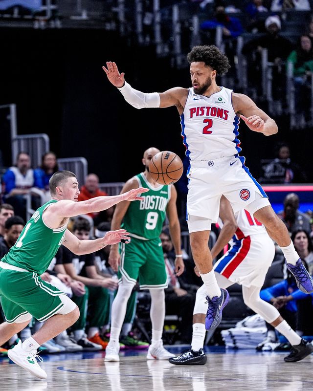Detroit Pistons guard Cade Cunningham (2) defends Boston Celtics guard Payton Pritchard (11) during the first half at Little Caesars Arena in Detroit on Monday, Jan. 19, 2026.