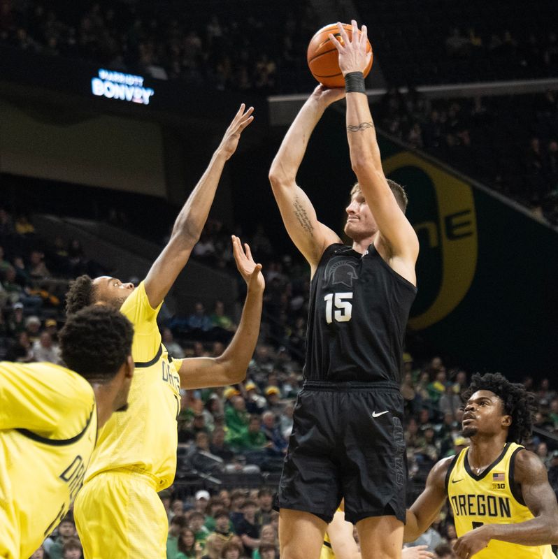 Michigan State’s Carson Cooper, right, shoots over Oregon’s Kwame Evans Jr. during the first half at Matthew Knight Arena in Eugene Jan. 20, 2026.