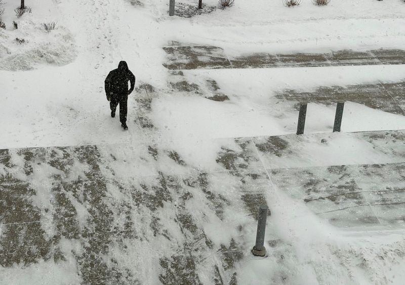 A man walks through the snow to get to the Wayne County County Criminal Justice Center in Detroit on Wednesday, Jan. 21, 2026.