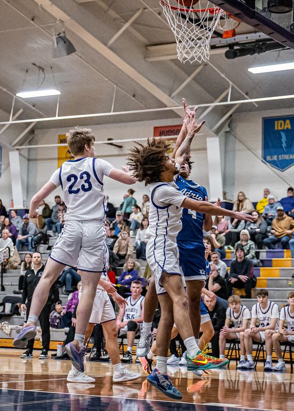 Adrian's Lamont McKinney (4) goes strong to the hoop while Onsted's Rylan Henagan (3) and Sean Symington (23) defend on Tuesday, January 20, 2026