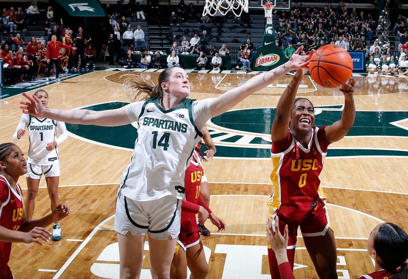 Michigan State's Grace VanSlooten, left, and USC's Vivian Iwuchukwu (0) fight for a rebound, Thursday, Jan. 22, 2026, in East Lansing.