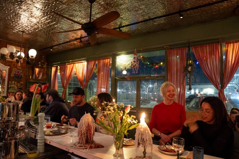 Molly Mitchell, second from right, chats with guests at Roses Fine Food in Detroit on Thursday, Jan. 15, 2026.