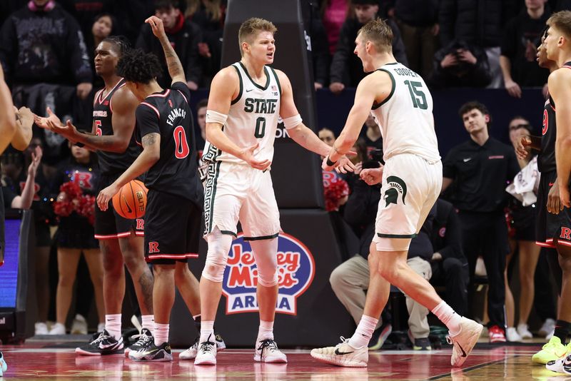 Michigan State Spartans forward Jaxon Kohler (0) reacts with center Carson Cooper (15) after scoring a basket during overtime against the Rutgers Scarlet Knights at Jersey Mike's Arena in Piscataway, New Jersey, on Tuesday, Jan. 27, 2026.