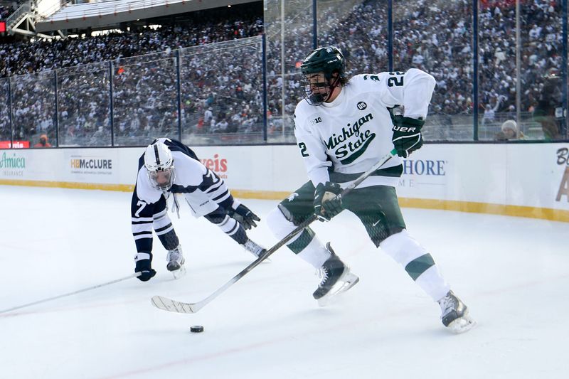 Jan 31, 2026; State College, PA, USA; Michigan State Spartans forward Porter Martone (22) moves the puck against Penn State Nittany Lions defenseman Jackson Smith (7) during the second period at Beaver Stadium. Mandatory Credit: Matthew O'Haren-Imagn Images