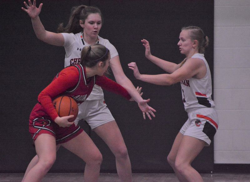 Cheboygan sophomore Diem Schley (back) and senior Addison Ptasnik (right) trap a Johannesburg-Lewiston player during the first half of a girls basketball game in Cheboygan on Saturday, Jan. 31.