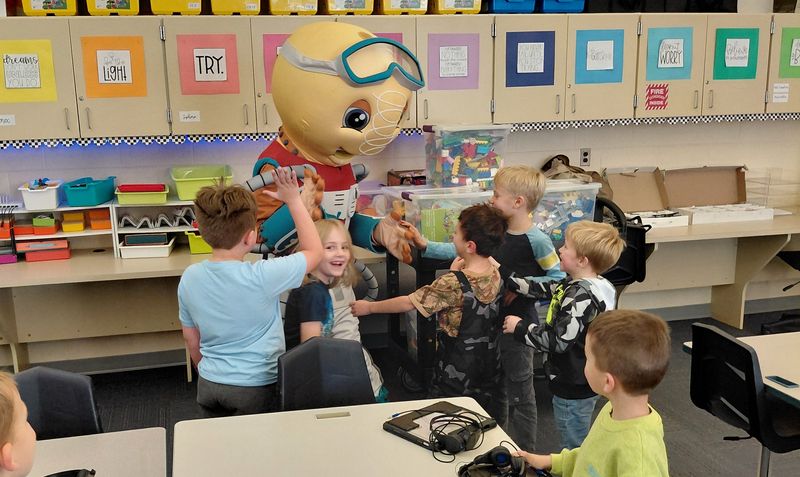 Char-Em Street STEM's mascot, Eureka, visits with students at Central Elementary School in Petoskey.