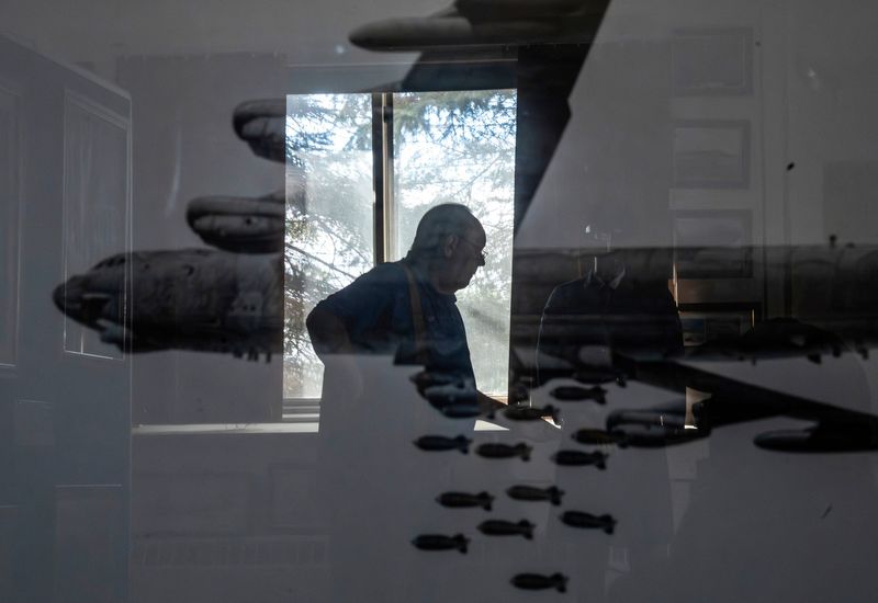 Richard Verwey, president of the K.I. Sawyer Heritage Air Museum, is reflected on a photo of a Boeing B-52 on display inside the museum on Monday, Oct. 27, 2025.