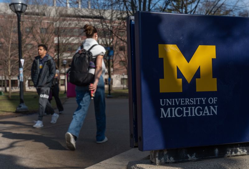 People walk near The Diag on the University of Michigan campus in Ann Arbor on Friday, March 28, 2025.