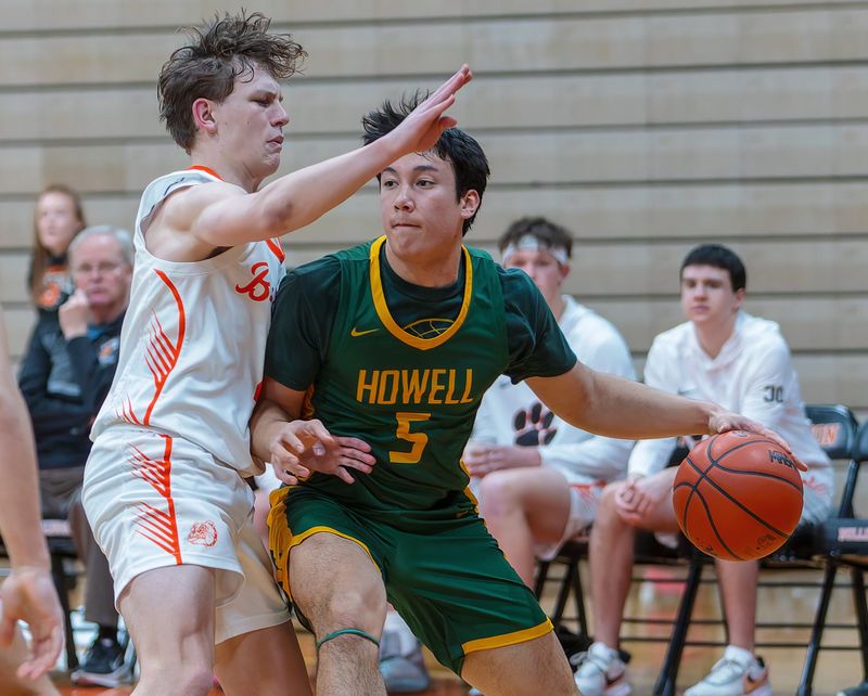 Howell's Danny Hampton (5) and Brighton's Brandon Lovejoy will meet in a district semifinal at Fenton.