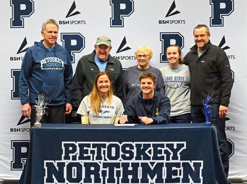Petoskey senior Braeden Flynn was joined by his family and Petoskey boys basketball coach Matt Tamm (far left), as he signed to continue his basketball career at Sault Ste. Marie's Lake Superior State Universtiy.
