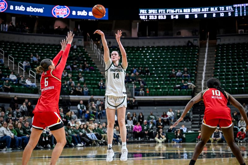 Michigan State's Grace VanSlooten, center, shoots as Maryland's Saylor Poffenbarger, left, defends during the second quarter on Wednesday, Feb. 4, 2026, at the Breslin Center in East Lansing.