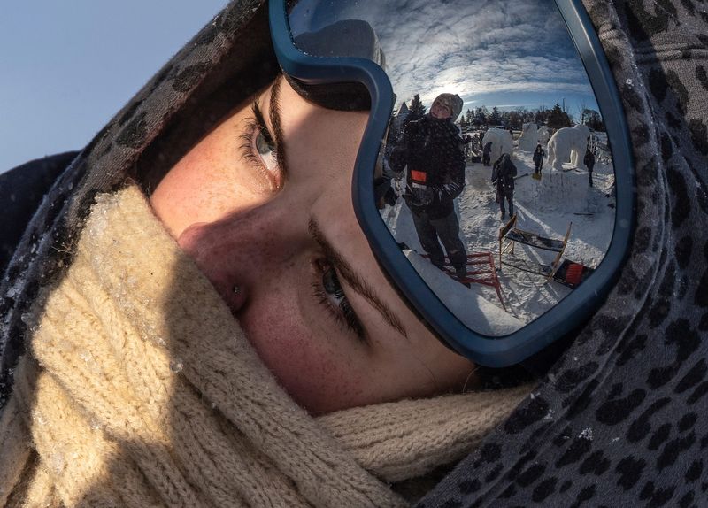 Ovid-Elsie High School senior Kailee Parker, left, bundles up from the bitter cold temperatures while she works with classmate Jolene Hebeler putting some of the finishing touches on their school’s snow sculpture while competing in the high school snow sculpting competition during the Zehnder’s Snowfest in Frankenmuth on Friday, January 30, 2026.