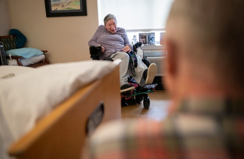 Warren Townsend, 71, looks in on his wife Pattie Townsend, 65, at their Medilodge residence in West Bloomfield on Monday, Feb. 2, 2026. They each receives $37 a month for their personal needs.