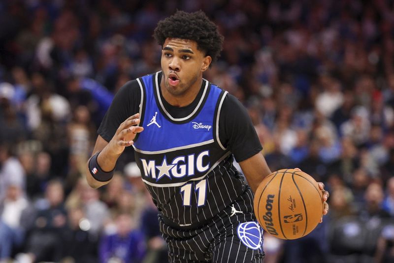Jan 22, 2026; Orlando, Florida, USA; Orlando Magic guard Jase Richardson (11) controls the ball against the Charlotte Hornets in the second quarter at Kia Center. Mandatory Credit: Nathan Ray Seebeck-Imagn Images