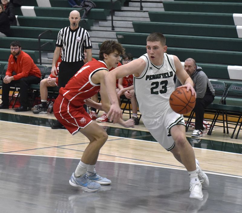 Pennfield junior Peyton Merlington drives to the basket during the St. Philip at Pennfield boys basketball game at Pennfield High School on Saturday, Feb. 7.