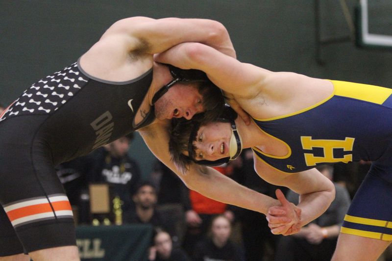 Brighton's Xander Courneya (left) and Hartland's Dallas Korponic battle in the 157-pound final during the KLAA wrestling tournament on Saturday, Feb. 7, 2026 at Howell High School.