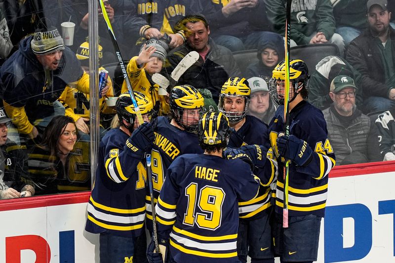Michigan players celebrate a goal against Michigan State during the third period of Duel in the D at Little Caesars Arena in Detroit on Saturday, February 7, 2026.