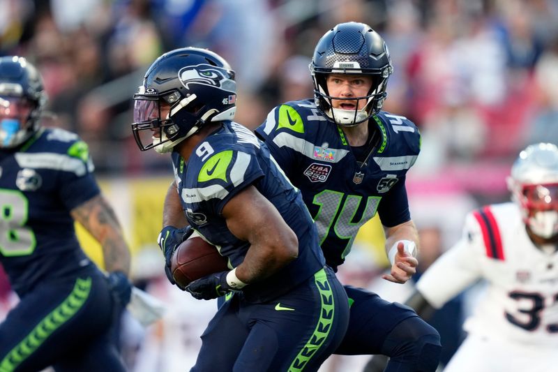 Seattle Seahawks quarterback Sam Darnold (14) hands off to running back Kenneth Walker III (9) during the first quarter against the New England Patriots in Super Bowl LX at Levi's Stadium in Santa Clara, California, on Sunday Feb. 8, 2026.