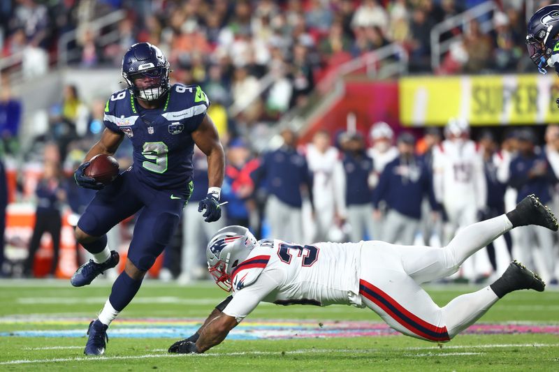 Feb 8, 2026; Santa Clara, CA, USA; Seattle Seahawks running back Kenneth Walker III (9) runs against New England Patriots linebacker Anfernee Jennings (33) during the fourth quarter in Super Bowl LX at Levi's Stadium. Mandatory Credit: Mark J. Rebilas-Imagn Images