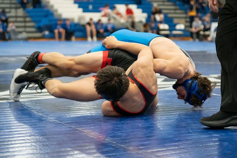 Harper Creek's Landen Sawyer competes against Marshall's Carlos Maddux during the Interstate 8 conference championship meet at Harper Creek High School on Saturday, Feb 7, 2026.