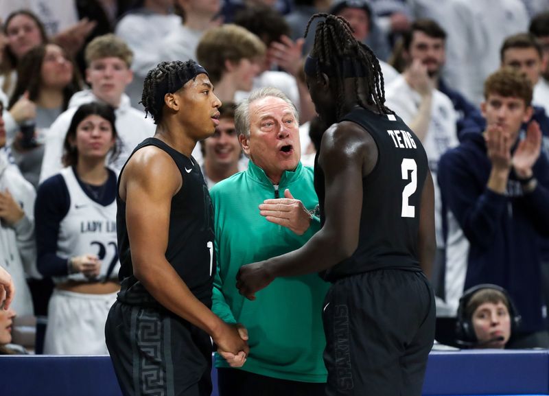 Dec 13, 2025; University Park, Pennsylvania, USA; Michigan State Spartans head coach Tom Izzo talks with guard Jeremy Fears Jr (1) and guard Kur Teng (2) during the second half against the Penn State Nittany Lions at Bryce Jordan Center. Mandatory Credit: Matthew O'Haren-Imagn Images
