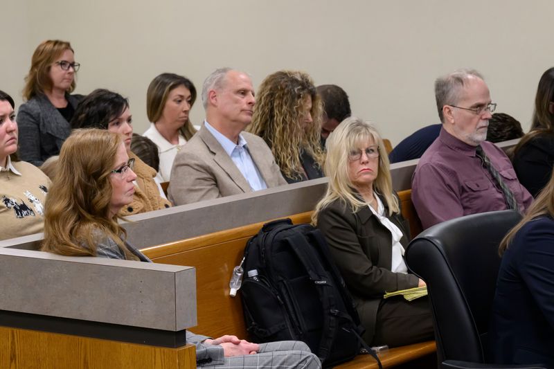 (From left) Tamela Peterson, Gary Marken (in beige suit), Aleta Moffitt (with glasses), and Jeffrey Mosteller (in purple), during a hearing in Oakland County District Court, in Troy, February 10, 2026. Judge Maureen McGinnis ruled the owner and three employees of a local medical facility, where a 5-year-old boy died last year in a hyperbaric oxygen chamber explosion, should stand trial on second-degree murder and involuntary manslaughter charges.