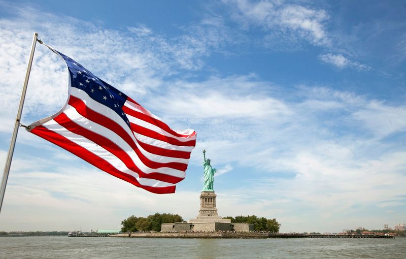 An U.S. flag waves in the wind on a boat near the Statue of Liberty in New York August 31, 2011. REUTERS/Lucas Jackson (UNITED STATES - Tags: CITYSPACE)