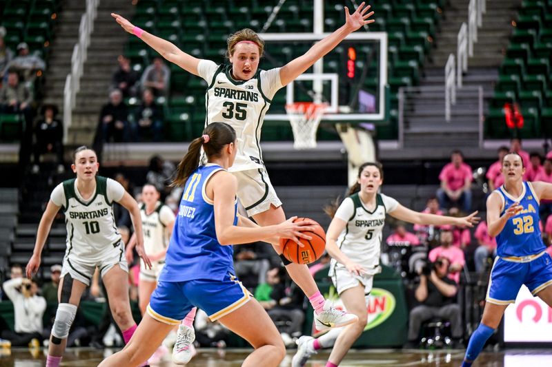 Michigan State's Kennedy Blair, top, jumps up while defending UCLA's Gabriela Jaquez during the third quarter on Wednesday, Feb. 11, 2026, at the Breslin Center in East Lansing.