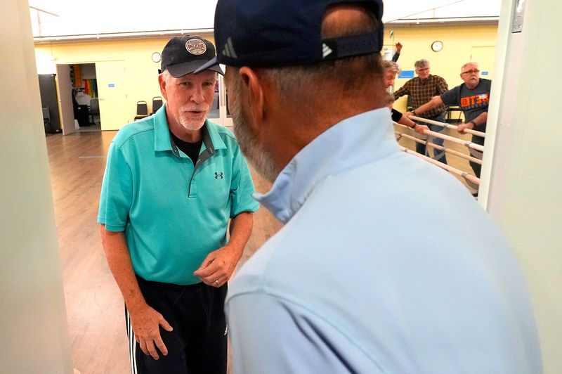 Mike Doran, of Waterford, greets Kirk Gibson as they get ready to play ping pong at the Kirk Gibson Center for Parkinson’s Wellness in Farmington Hills on Friday, Dec. 19, 2025.