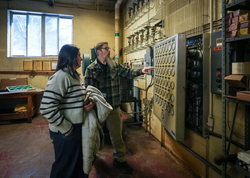 Ingham Intermediate School District District Facilities and Safety Director Steve Rusnock shows Jayme Taylor outdated equipment, Friday, Jan. 30, 2026, in the facilities room at the Beekman Center in Lansing.