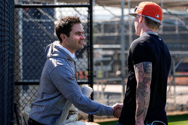 Detroit Tigers president of baseball operations Scott Harris, left, shakes hands with outfielder Max Clark at practice during spring training at TigerTown in Lakeland, Fla. on Friday, Feb. 13, 2026.