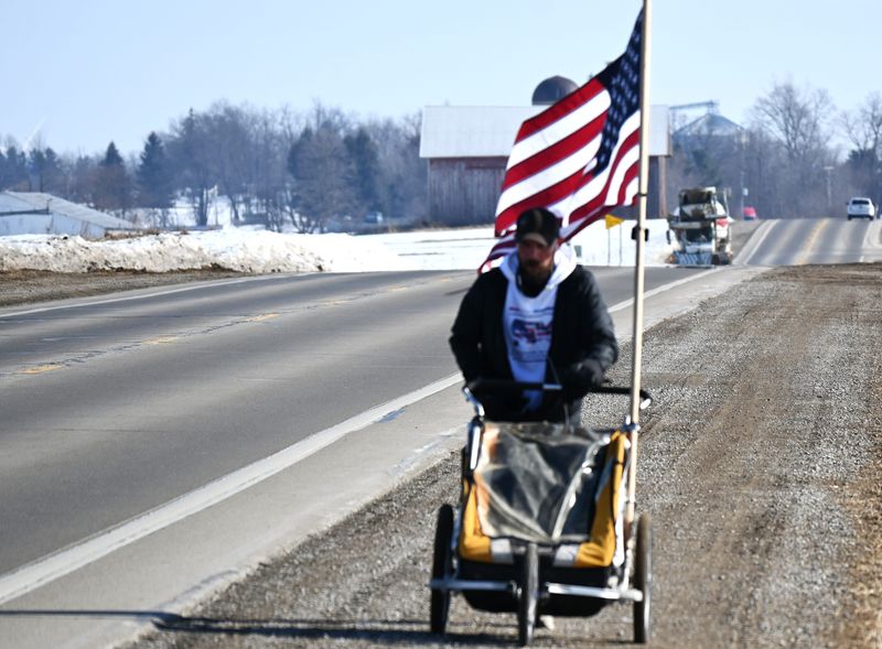 Noah Coughlan running along U.S. 12 on his way to Coldwater on Feb.13 as part of his Run Across America, touching all 50 states.