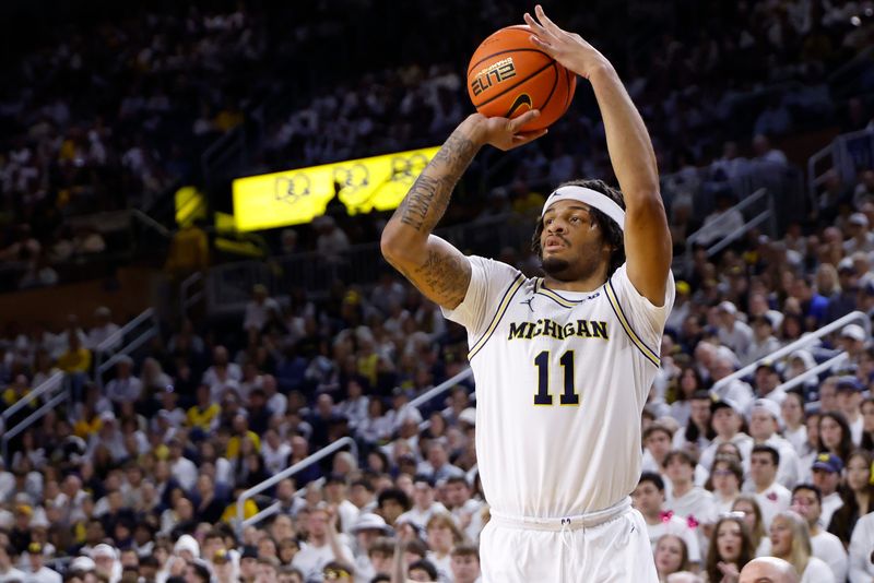 Feb 14, 2026; Ann Arbor, Michigan, USA; Michigan Wolverines guard Roddy Gayle Jr. (11) shoots in the first half against the UCLA Bruins at Crisler Center. Mandatory Credit: Rick Osentoski-Imagn Images