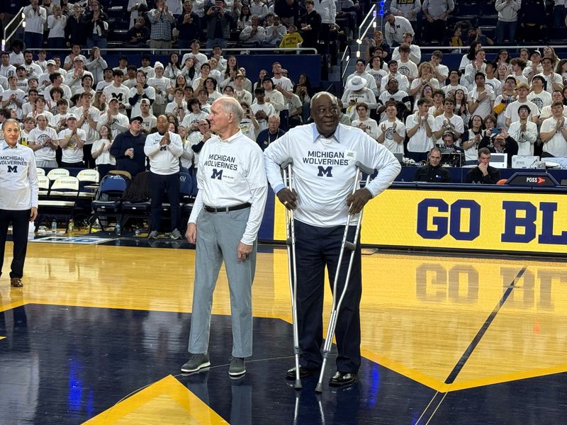 Marc Delzer and Cazzie Russell, members of the 1966 Big Ten champion Michigan basketball squad, receive an ovation at halftime against UCLA at Crisler Center in Ann Arbor on Saturday, Feb. 14, 2026.