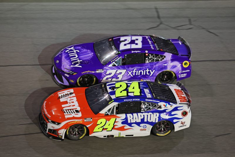 Feb 12, 2026; Daytona Beach, Florida, USA; Driver William Byron (24) and driver Bubba Wallace (23) race during the Duel 1 at Daytona at Daytona International Speedway.
