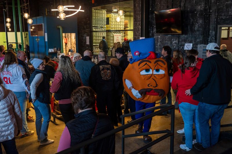 A person wearing a paczek costume makes his way through a crowd during the Detroit City Distillery’s annual Paczki Day Vodka event in Detroit on Saturday, Feb. 14, 2026.