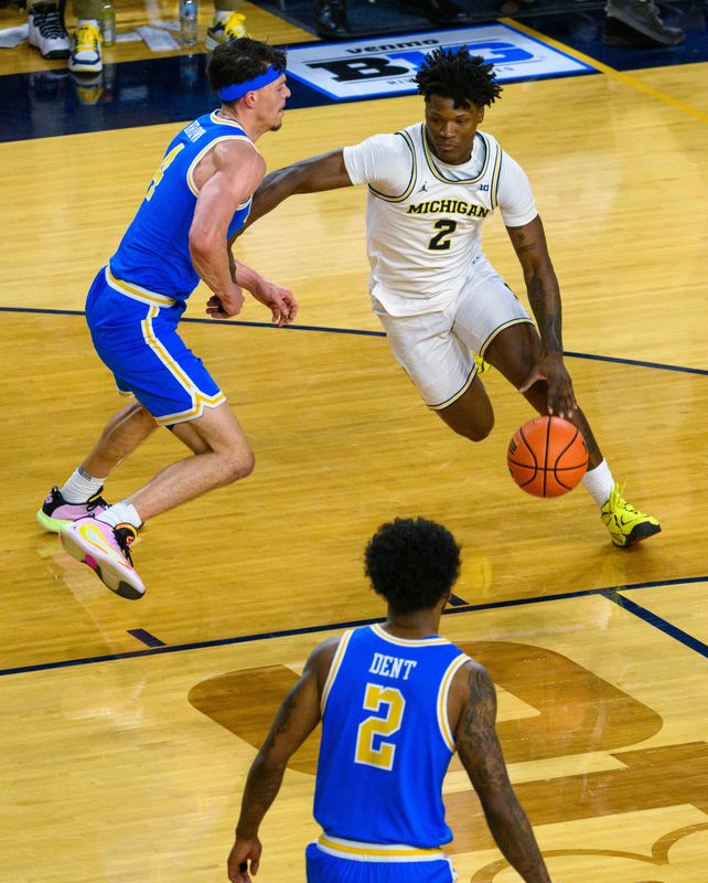 Michigan’s L.J. Cason dribbles around UCLA's Jamar Brown during the second half of the Wolverines’ 86-56 victory on Saturday.