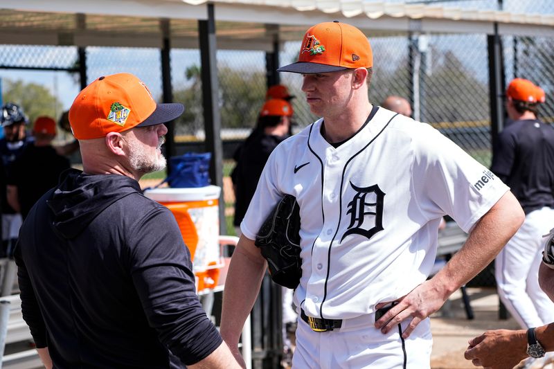 Detroit Tigers pitcher Troy Melton, right, talks to assistant pitching coach Robin Lund after practice during spring training at TigerTown in Lakeland, Fla. on Sunday, Feb. 15, 2026.