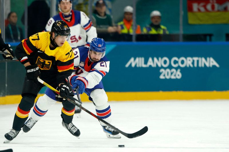 USA forward Dylan Larkin defends against Germany in Milan on Sunday, Feb. 15, 2026.