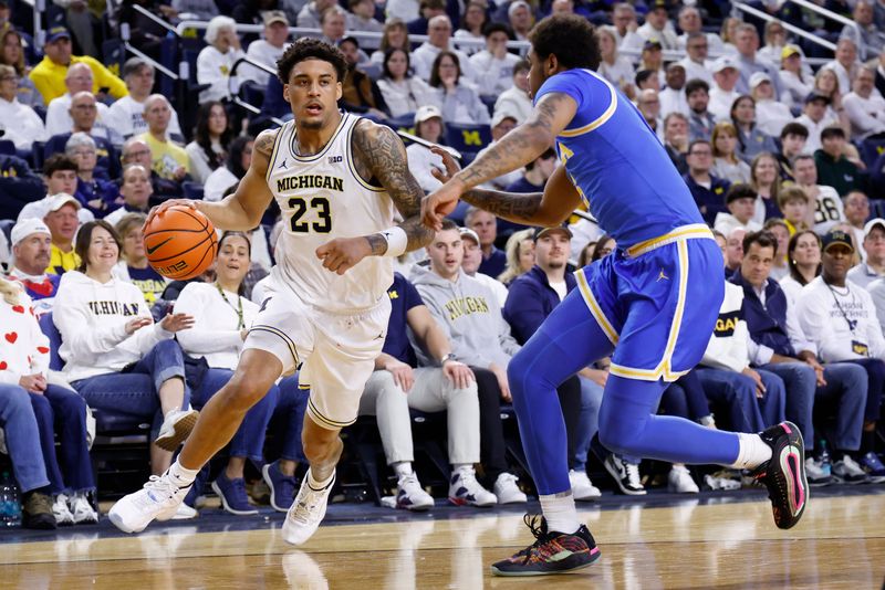 Michigan Wolverines forward Yaxel Lendeborg (23) on the move against UCLA Bruins guard Brandon Williams (5) in the first half at Crisler Center in Ann Arbor, Michigan.