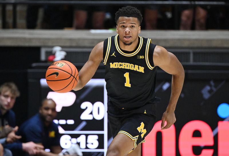 Michigan Wolverines guard Trey McKenney (1) drives the ball down court during the first half against the Purdue Boilermakers at Mackey Arena in West Lafayette, Indiana, on Tuesday, Feb. 17, 2026.